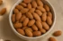 Premium almond bowl on warm linen with loose kernels and brass spoon, Ammari Foods cover image